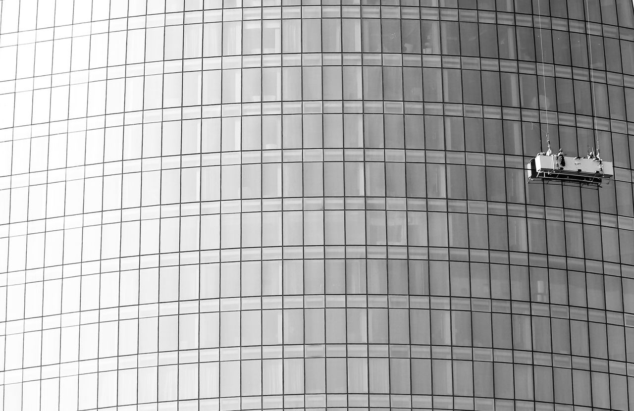 project-01-c High-rise glass facade with suspended platform for window cleaning.